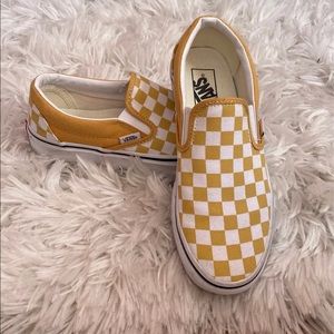 Woman’s mustard yellow slip on Vans